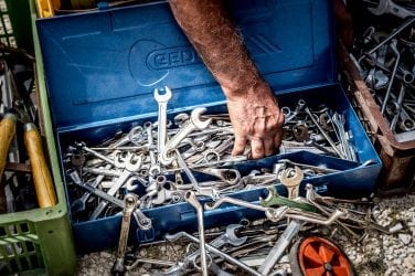 Man searching for tools in his toolboxs