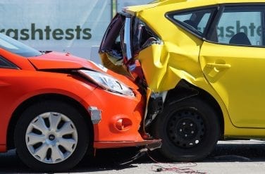 Red car collides with yellow vehicle