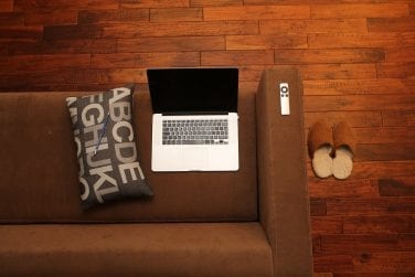Remote business laptop placed on a couch